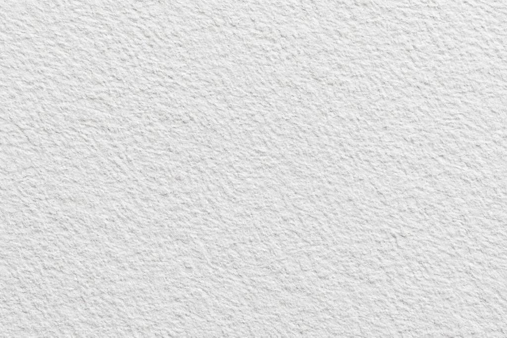 White paper with coarse irregular grain, small ridges and visible surface relief
